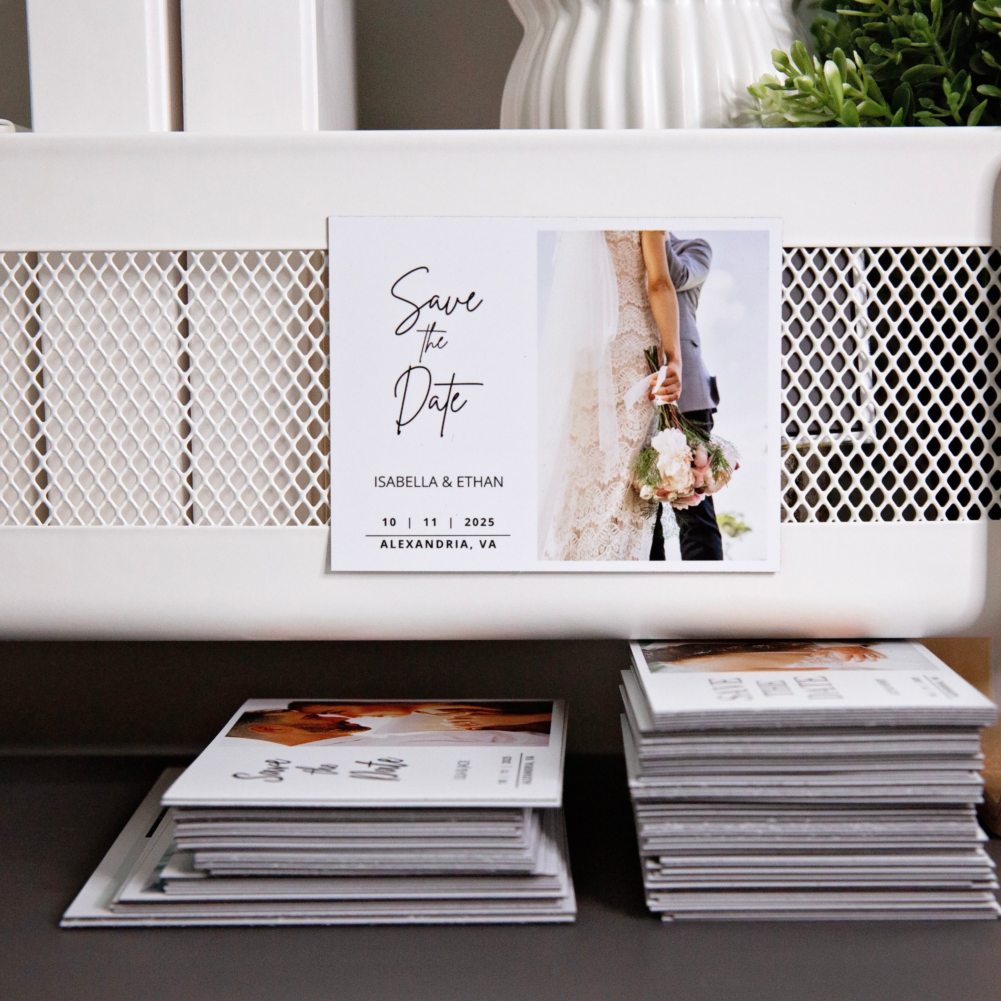 Stack of custom flexible wedding magnets with floral design and engaged couple imagery on white background.